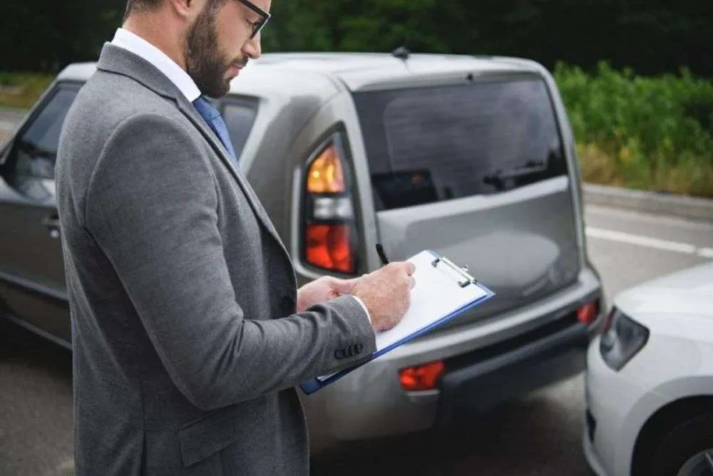 New Orleans Insurance representative writing an estimate for an automotive accident