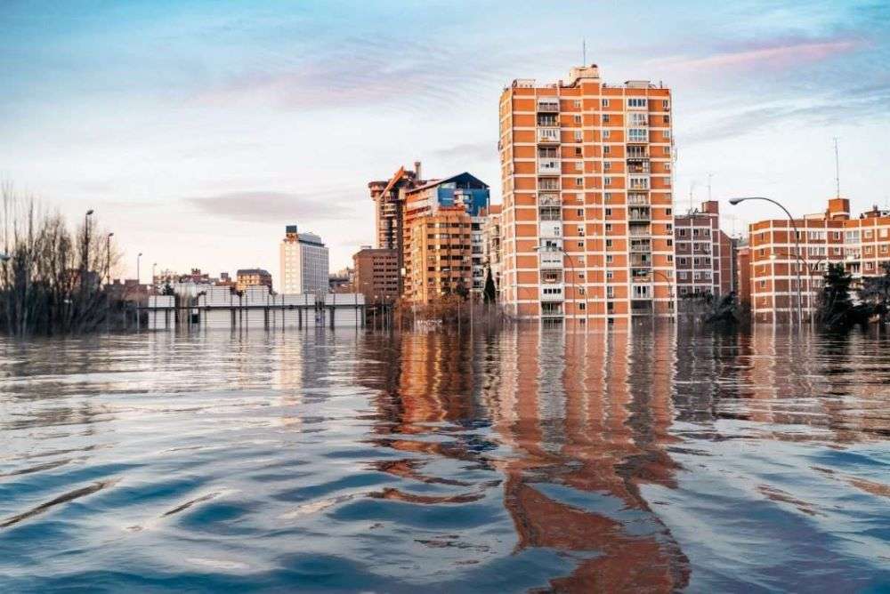 Floodwaters surround a commercial building after a storm