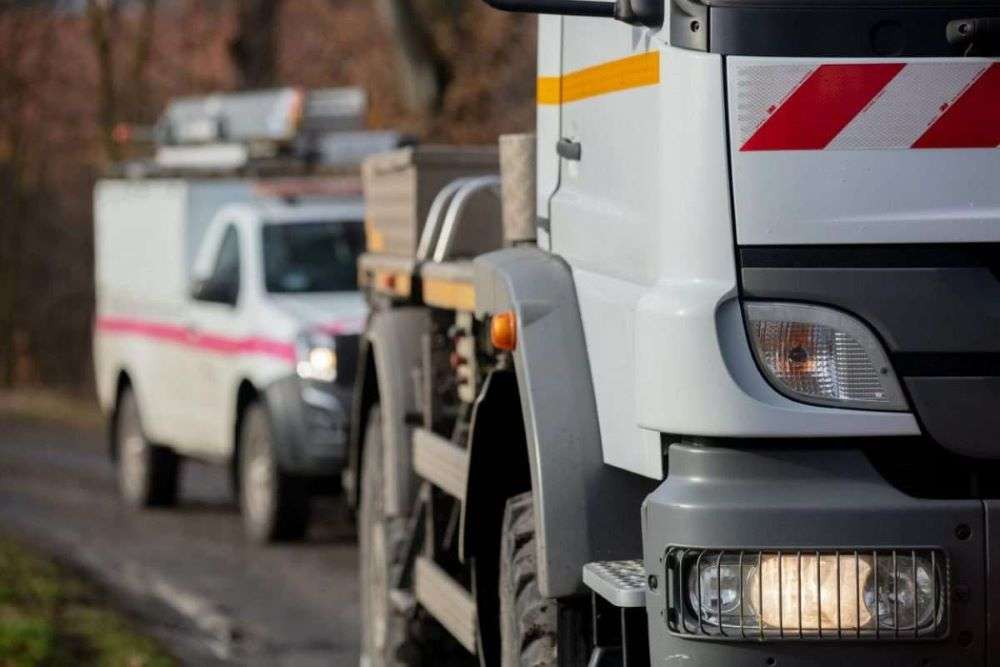 Commercial vehicles driving to a work site