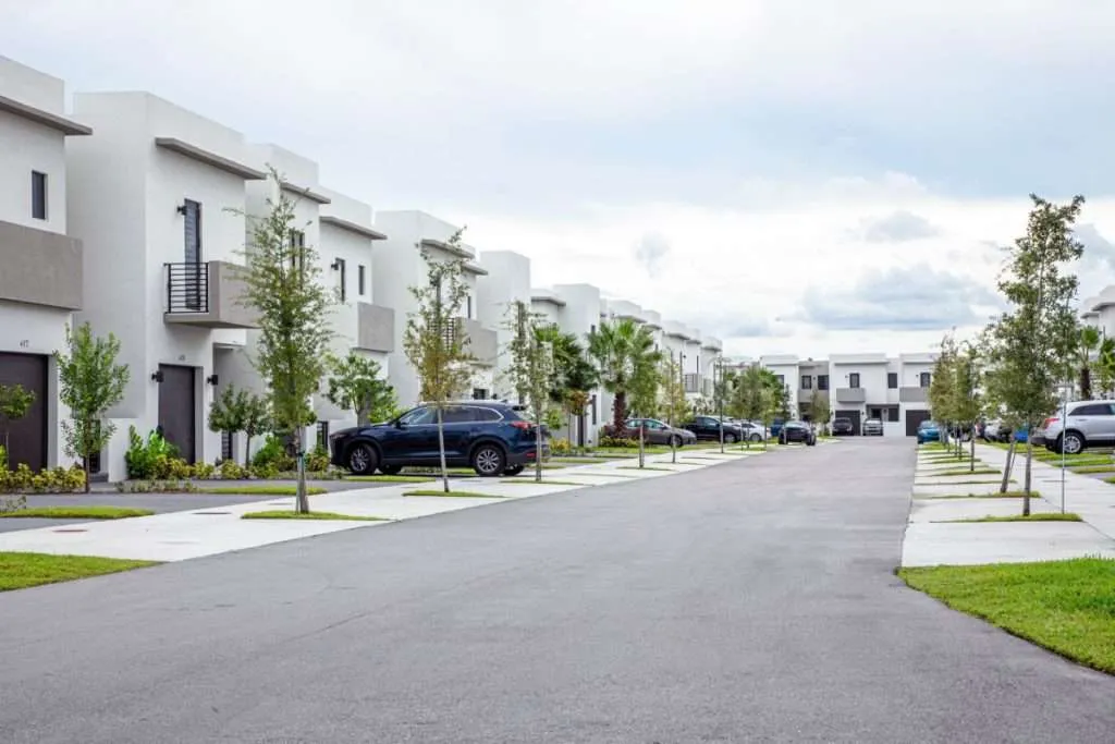 Modern condos line a street in a residential area