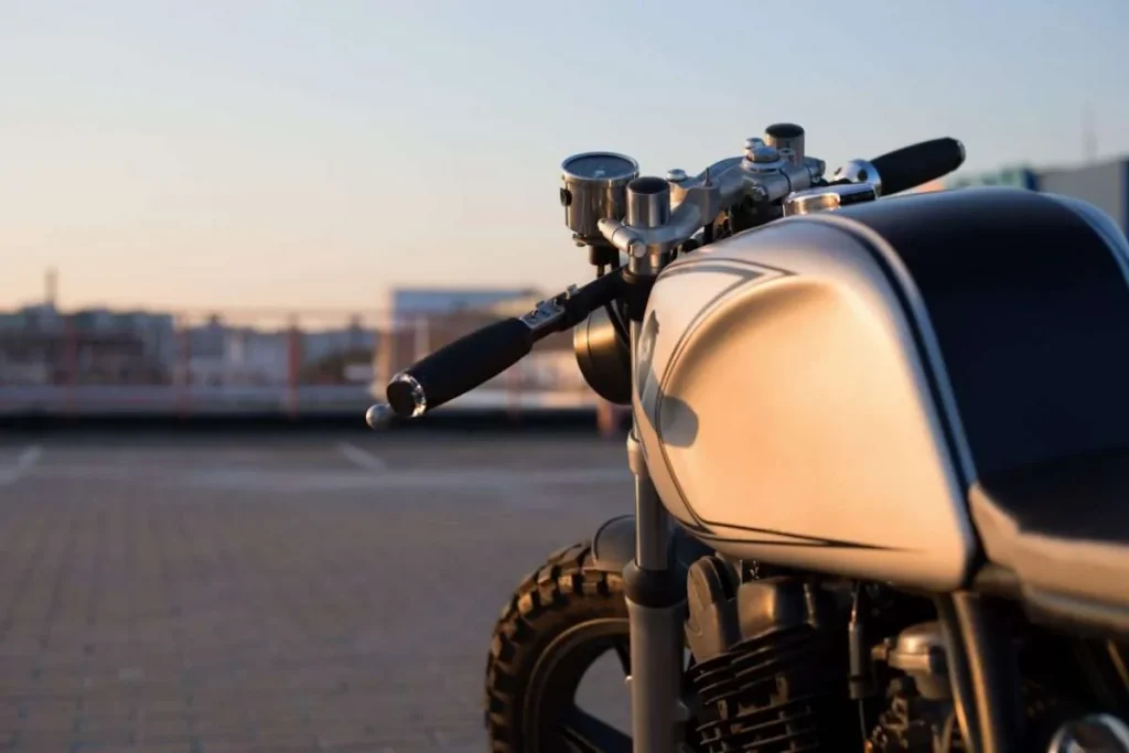 Custom vintage motorcycle in a parking lot at sunset