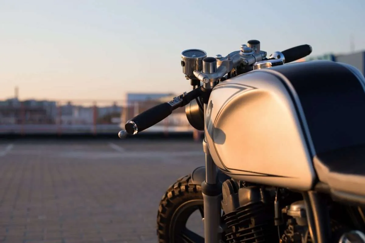 Custom vintage motorcycle in a parking lot at sunset